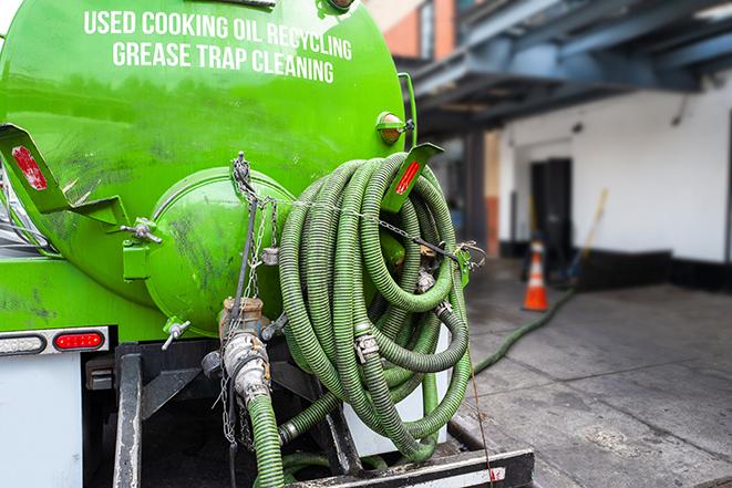 a service truck pumping grease from a restaurant's grease trap in Ballico